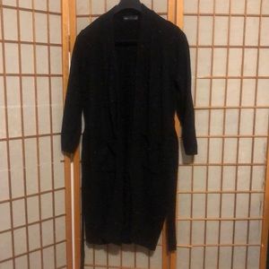 Long sweater jacket with belt.  Black with a few colored fabric spots.